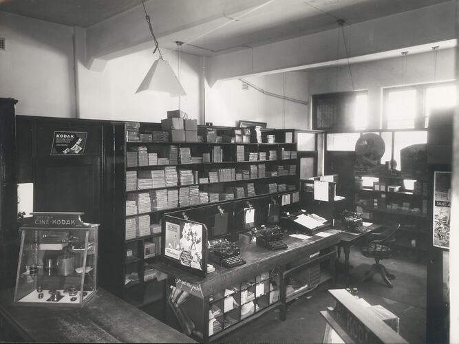 Wood-panelled shop interior with Kodak products.