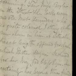 Open diary with handwritten text on discoloured worn page.