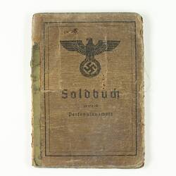 Book with brown cover, with eagle above swastika and printed text.