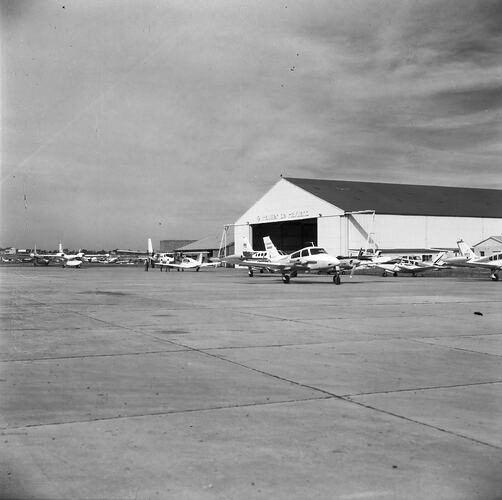 Monochrome image of an aircraft hangar.