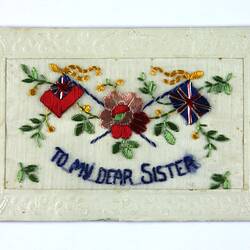 Front of postcard with floral embroidery.