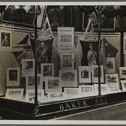 Shopfront display with commemorative prints of Silver Jubilee.