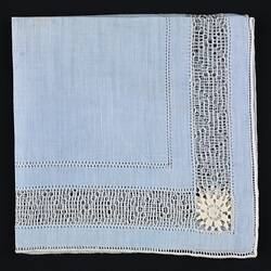Folded blue handkerchief with Crocheted Inner Border.