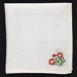 Folded white Handkerchief with embroidered dark pink flowers.