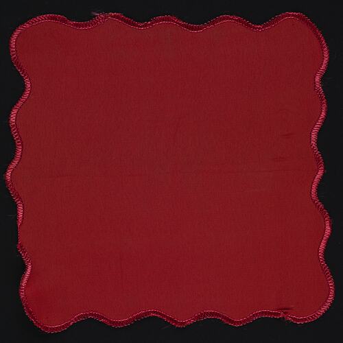 Crimson silk handkerchief with wavy border.