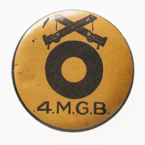 Round yellow badge with black logo and text below.