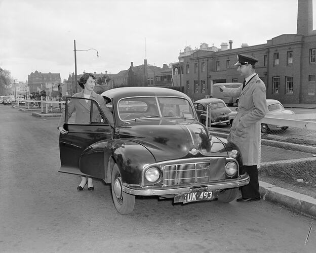 Woman with Motor Car and Policeman, Melbourne, Victoria, Jul 1958