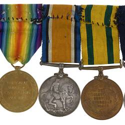 Group of five medals with ribbons joined together in a row.