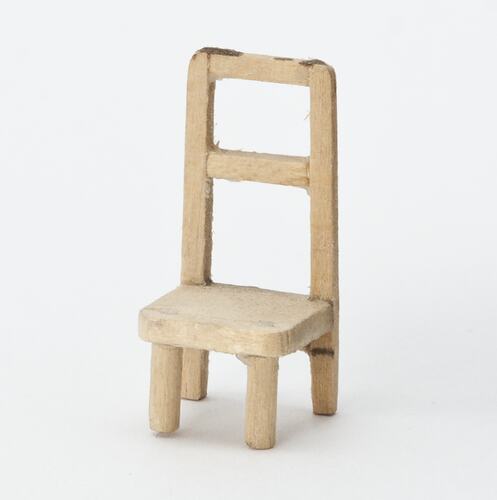 Pale wooden chair from doll's house.