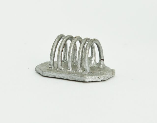 Miniature silver toast rack from a doll's house.