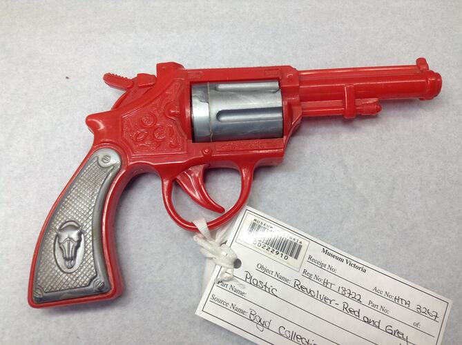 Red and grey plastic toy revolver.