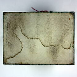 Underside of box with water stain.