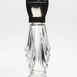 Clear glass perfume bottle, tear shaped, gold plastic lid. Profile.