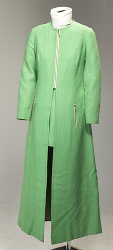 Lime green linen long-sleeved maxi coat with front metal zipper and zipper pockets.