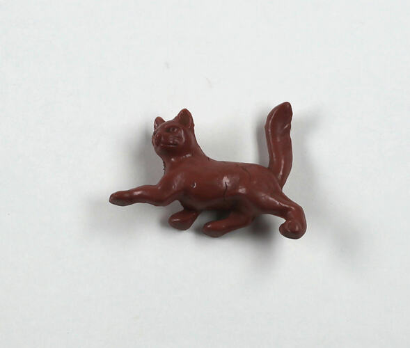 Toy brown cat, front view.