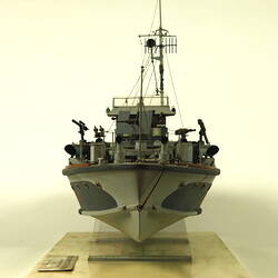 Dark and light grey ship, front view.