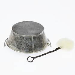 Miniature silver cleaning pan, base side up, and brush. Brush has twisted wire handle and white scourer at end
