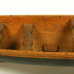 Wooden boat with black hull, centre detail.