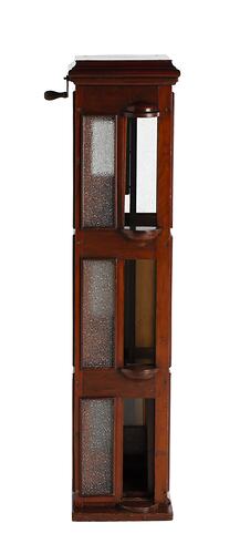 Wooden passenger lift model with 3 floors, each with opaque glass windows and sliding door. Handle at top left