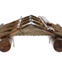 Raft model made of wood and twine. Two cylindrical floats are attached to framework.