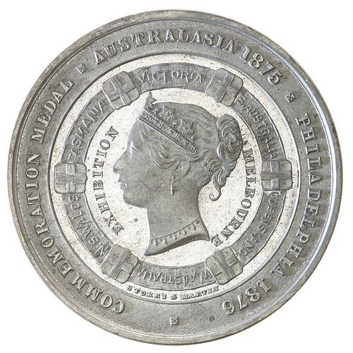 Silver round medal. Within a ring divided by six shields, head of Queen Victoria facing left wearing coronet.