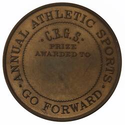 Round medal with text in centre and around edge.