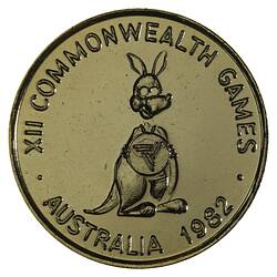 Round gilt medal with kangaroo caricature standing facing 3/4 right holding Brisbane Commonwealth Games logo.