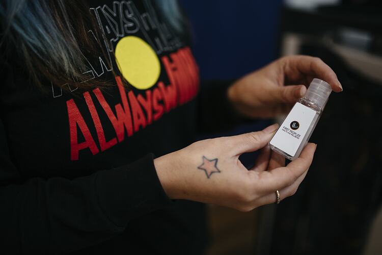 Staff Member Holds Hand Sanitiser at First Peoples Health and Wellbeing Clinic, Thomastown, Wurundjeri Woi Wurrung Country, Victoria, 25 Mar 2021