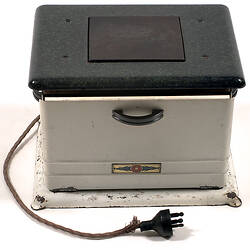 Portable stove showing side, top and plug.
