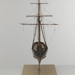 Black and red sailing ship model. Front view.