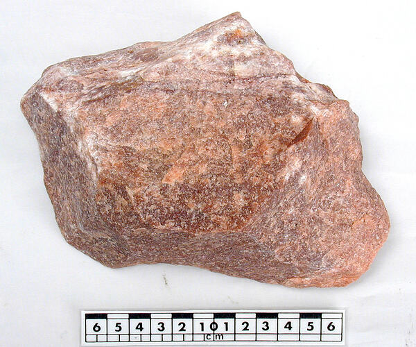 Pink mineral sample with scalebar.