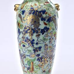 Porcelain vase with all-over pattern of birds, flowers, butterflies and two rats climbing amongst branches.