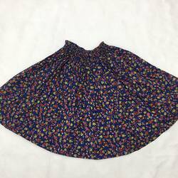 Child's skirt, blue floral print with gathered waist.