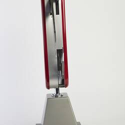 Model of muti-tool on stand. Red handle with all tools out. Side view.