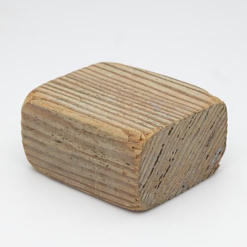 Block of pale-coloured wood.