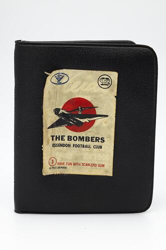 Brown vinyl wallet, white label with bomber plane and text.