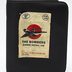 Brown vinyl wallet, white label with bomber plane and text.