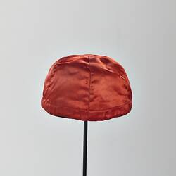 Back of red silk jockey cap.