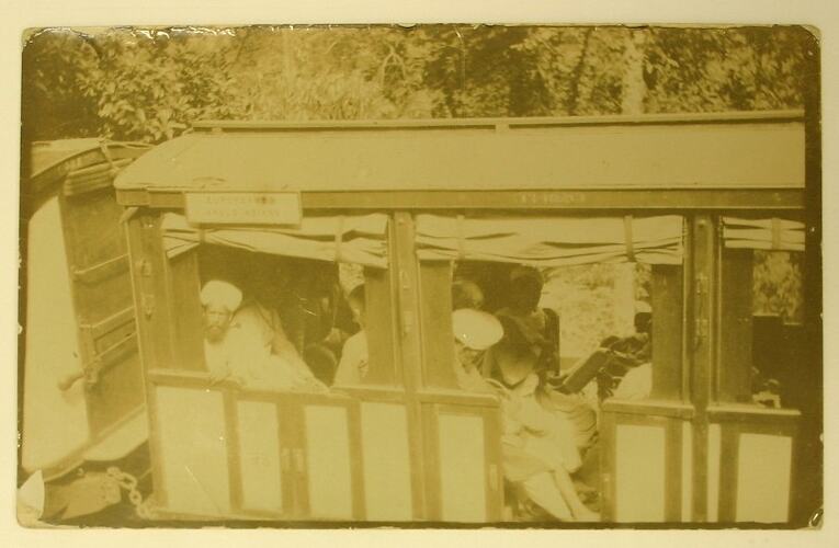 Local people in open railway carriage.