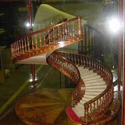 Model of a wooden staircase in a glass case.