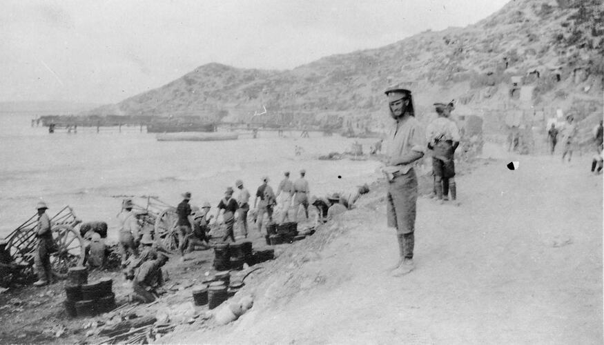 Portion of Hell's Spit Anzac Beach showing soldiers carting supplies from the beach.