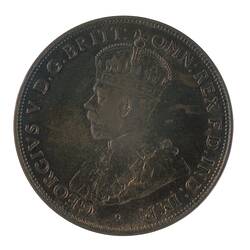 Round bronze coin featuring crowned and robed bust of George V facing left. Text around.