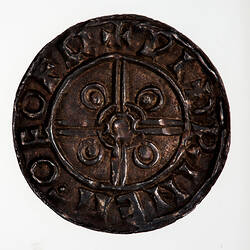 Coin, round, short cross, voided with the base of the arms joined at the centre by two circles.