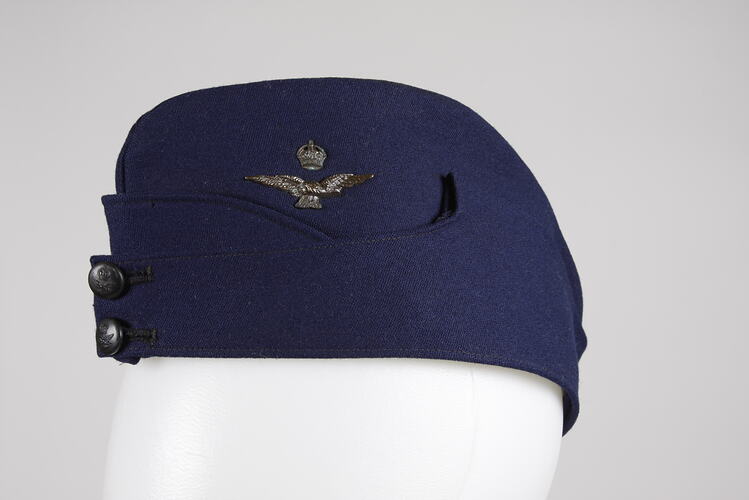Blue Air Force uniform cap, with eagle and crown pin.