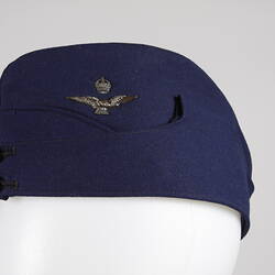 Blue Air Force uniform cap, with eagle and crown pin.