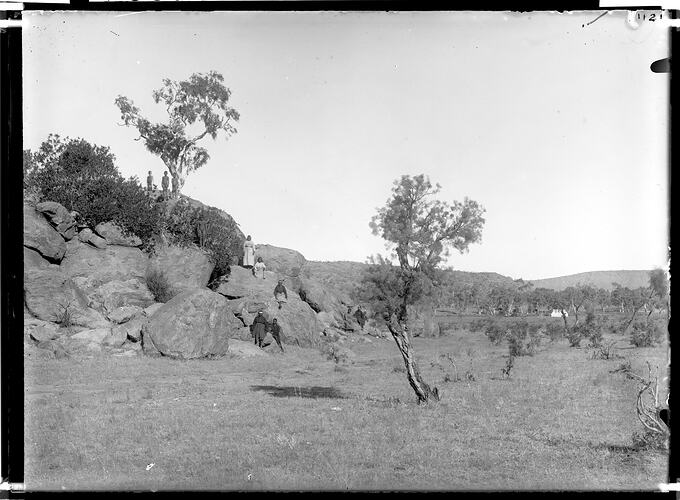 Arrernte people living near the Alice Springs Telegraph Station, with a camp (probably Spencer and Gillen's Expedition camp) in the background, Alice Springs, April-May 1901