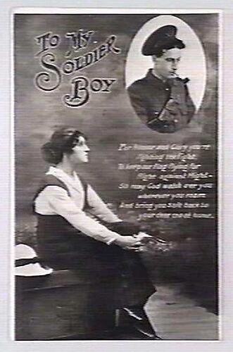 Front of postcard depicting woman looking at soldier's image.