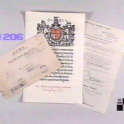 Stamped envelope with two documents, first document contains a large coat of arms printed above the text.
