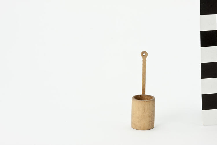 Round wooden dipper on a long handle.