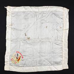 Back of white handkerchief with embroidered bottom right corner.
